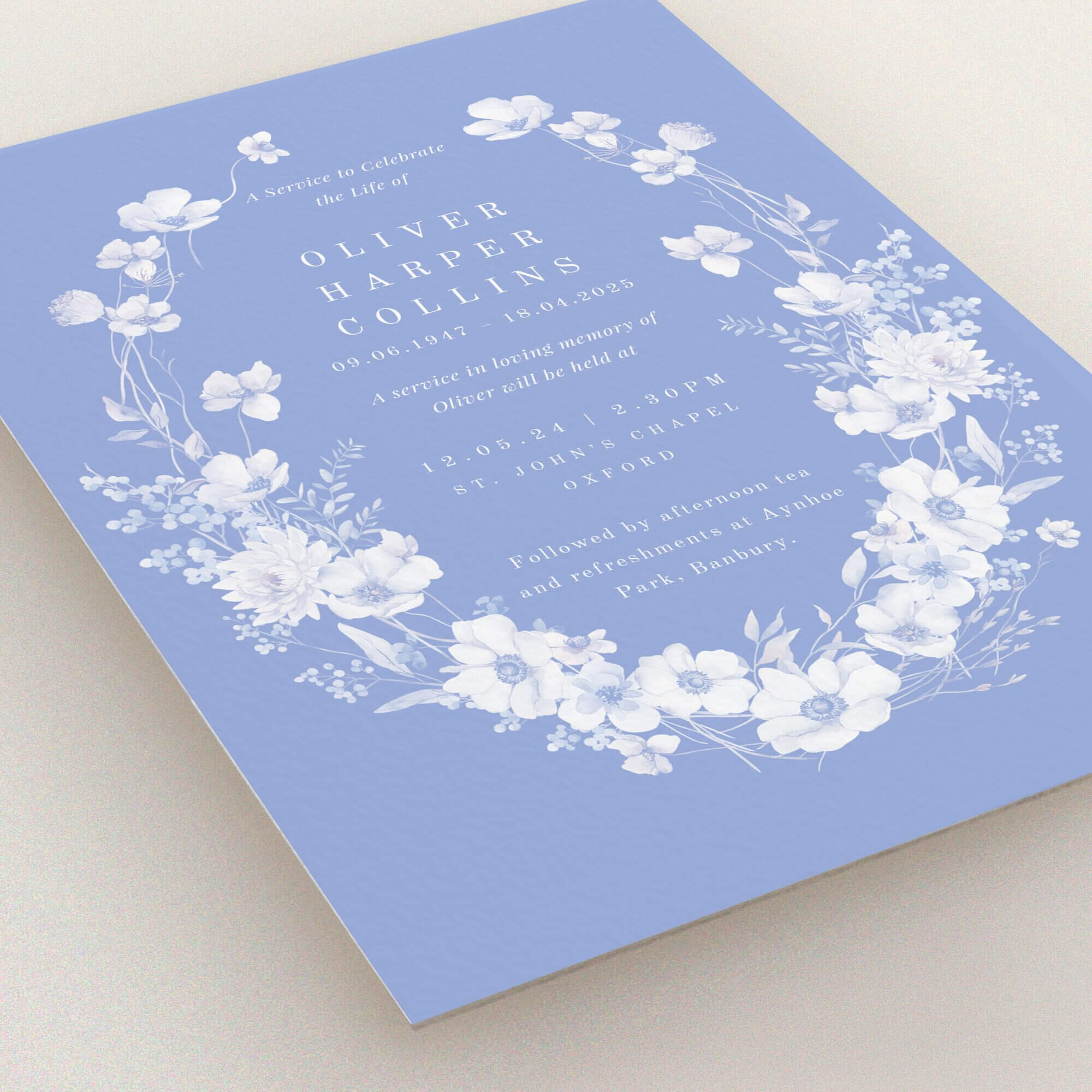Floral funeral announcement design with blue background, featuring two white floral illustrations.