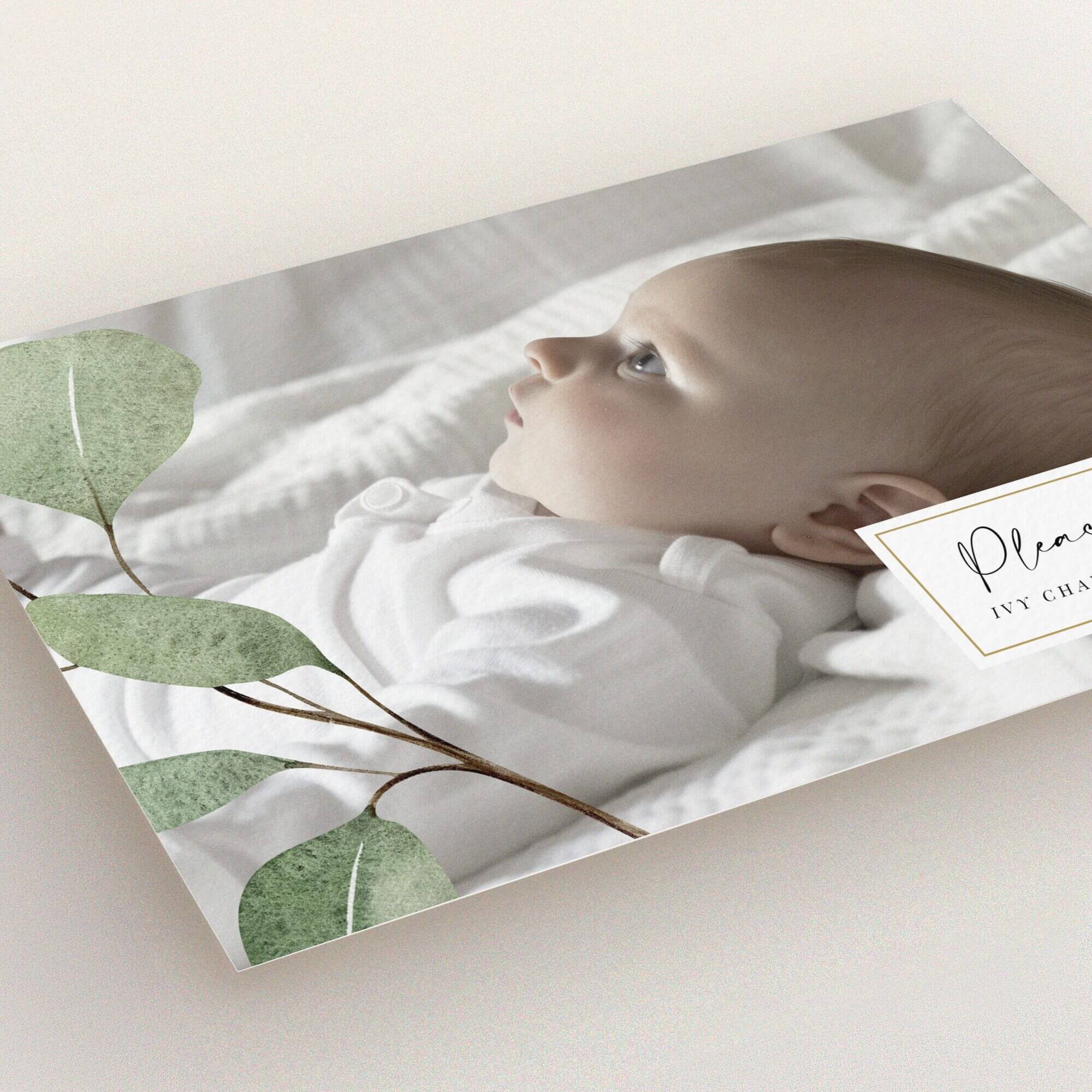 Birth announcement card featuring a minimalist design with one photo of a baby and botanical elements.