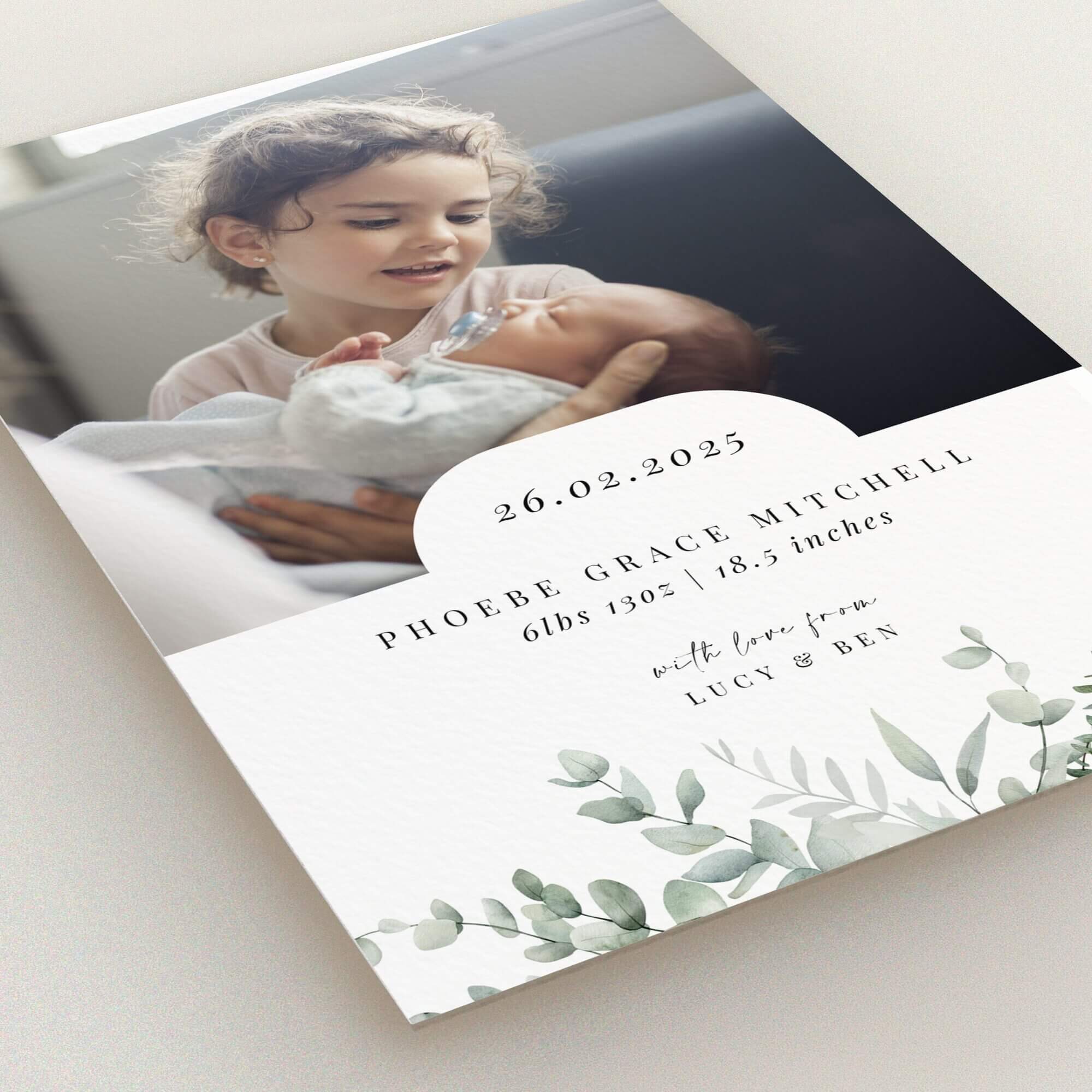 Elegant birth announcement card with floral accents and one photo.