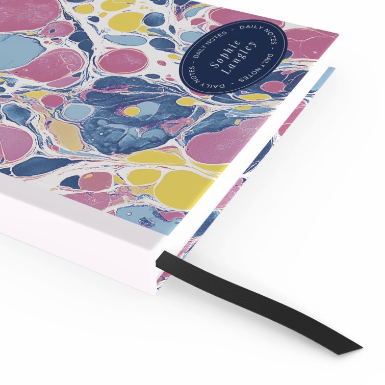 Colourful marbled design for personalised notebooks with space for daily notes and name.