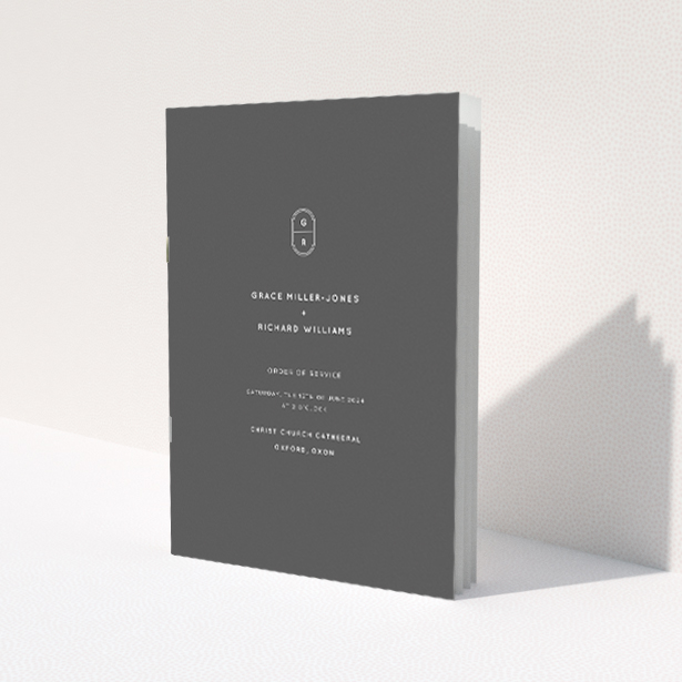 'Midnight Monogram wedding order of service booklet featuring sleek modern design with bold monochromatic colour scheme and personalised monogram emblem.'. This is a view of the front