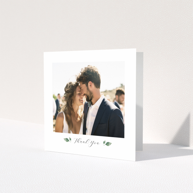 Wedding thank you card with 1 photo featuring a couple embracing and elegant floral accents.