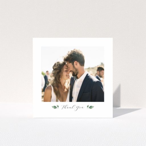 Wedding thank you card with 1 photo featuring a couple embracing and elegant floral accents.