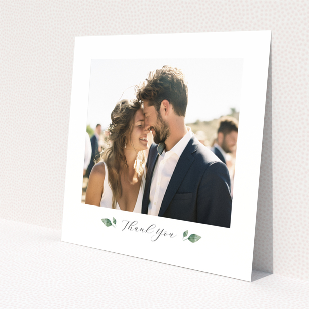 Wedding thank you card with 1 photo featuring a couple embracing and elegant floral accents.