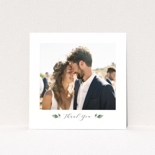Wedding thank you card with 1 photo featuring a couple embracing and elegant floral accents.