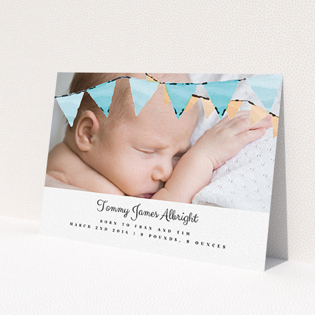 A new baby announcement card design called "Blue Bunting". It is an A6 card in a landscape orientation. It is a photographic new baby announcement card with room for 1 photo. "Blue Bunting" is available as a flat card, with tones of blue and white.