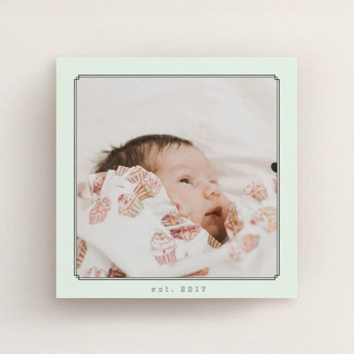 A new baby announcement card template titled "Deco Mint Frame". It is a square (148mm x 148mm) card in a square orientation. It is a photographic new baby announcement card with room for 1 photo. "Deco Mint Frame" is available as a flat card, with mainly green colouring.