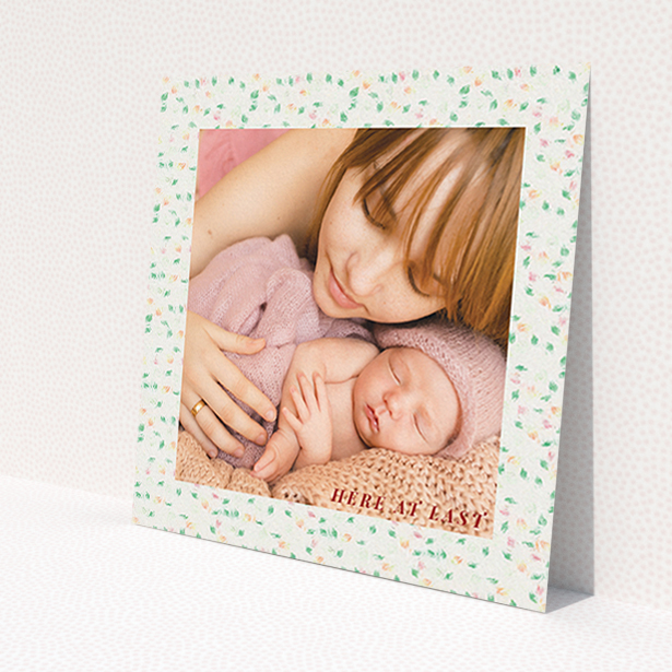 A new baby announcement card design called 'Floral abstract'. It is a square (148mm x 148mm) card in a square orientation. It is a photographic new baby announcement card with room for 1 photo. 'Floral abstract' is available as a flat card, with tones of light cream and green.