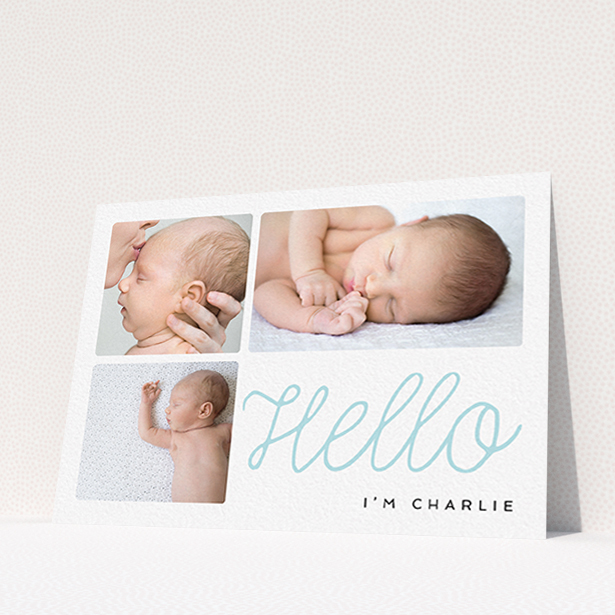 A new baby announcement card template titled "Hello Cursive". It is an A6 card in a landscape orientation. It is a photographic new baby announcement card with room for 3 photos. "Hello Cursive" is available as a flat card, with tones of white and blue.
