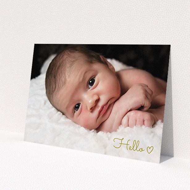 A new baby announcement card design named 'Hello'. It is an A5 card in a landscape orientation. It is a photographic new baby announcement card with room for 1 photo. 'Hello' is available as a flat card, with mainly gold colouring.