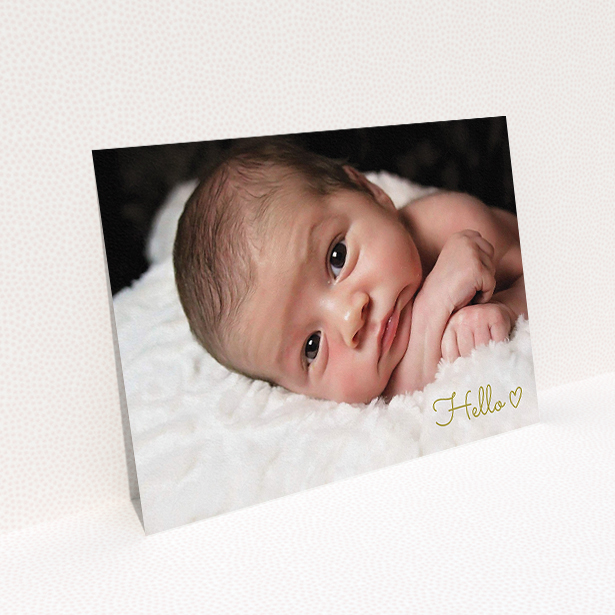 A new baby announcement card design named "Hello". It is an A5 card in a landscape orientation. It is a photographic new baby announcement card with room for 1 photo. "Hello" is available as a flat card, with mainly gold colouring.