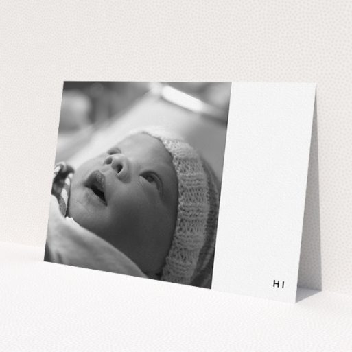 A new baby announcement card design titled 'HI'. It is an A5 card in a landscape orientation. It is a photographic new baby announcement card with room for 1 photo. 'HI' is available as a flat card, with tones of black and white.