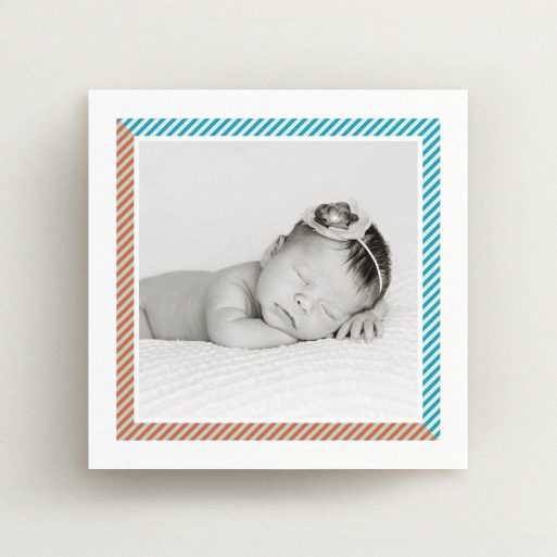 A new baby announcement card template titled "Kensington Square". It is a square (148mm x 148mm) card in a square orientation. It is a photographic new baby announcement card with room for 1 photo. "Kensington Square" is available as a flat card, with tones of white, blue and red.