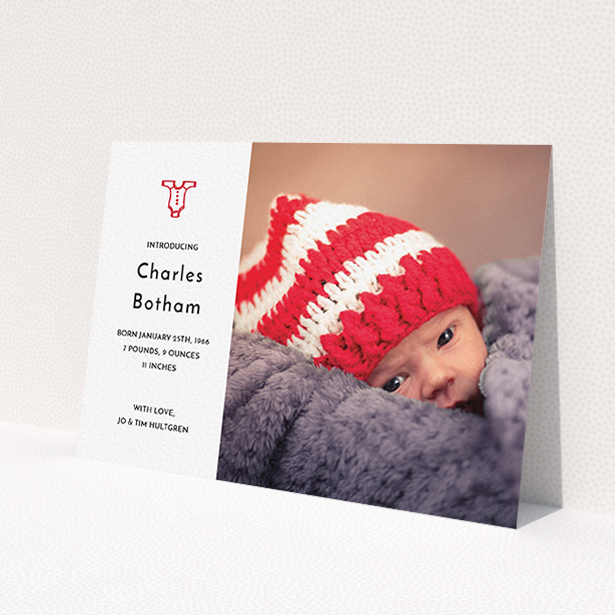 A new baby announcement card named "Onesie". It is an A6 card in a landscape orientation. It is a photographic new baby announcement card with room for 1 photo. "Onesie" is available as a flat card, with tones of white and red.