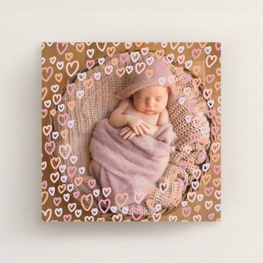 A new baby announcement card design named "Pink Hearts". It is a square (148mm x 148mm) card in a square orientation. It is a photographic new baby announcement card with room for 1 photo. "Pink Hearts" is available as a flat card, with mainly light pink colouring.