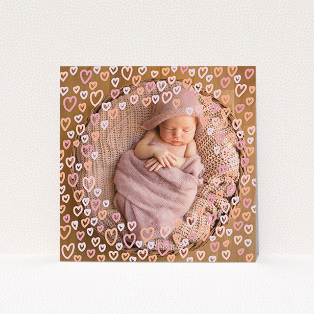 A new baby announcement card design named "Pink Hearts". It is a square (148mm x 148mm) card in a square orientation. It is a photographic new baby announcement card with room for 1 photo. "Pink Hearts" is available as a flat card, with mainly light pink colouring.