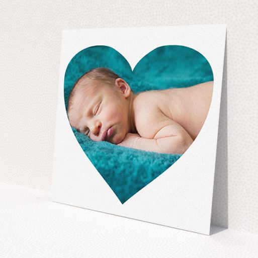A new baby announcement card design titled 'Simple Heart Frame'. It is a square (148mm x 148mm) card in a square orientation. It is a photographic new baby announcement card with room for 1 photo. 'Simple Heart Frame' is available as a flat card, with mainly white colouring.