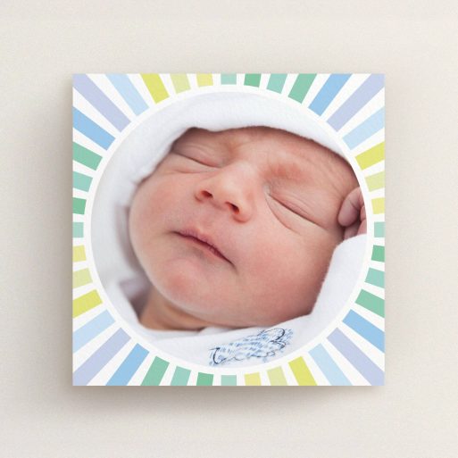 A new baby announcement card design named "Sun Centre". It is a square (148mm x 148mm) card in a square orientation. It is a photographic new baby announcement card with room for 1 photo. "Sun Centre" is available as a flat card, with mainly light blue colouring.