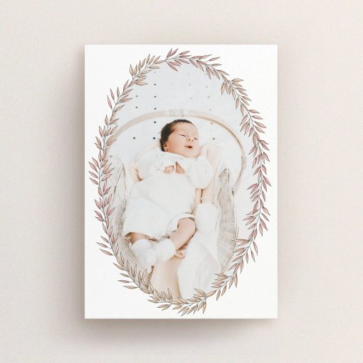 A new baby announcement card design titled "Tussled Wreath". It is an A6 card in a portrait orientation. It is a photographic new baby announcement card with room for 1 photo. "Tussled Wreath" is available as a flat card, with tones of pink and white.