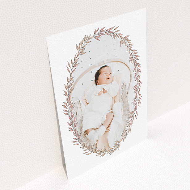 A new baby announcement card design titled "Tussled Wreath". It is an A6 card in a portrait orientation. It is a photographic new baby announcement card with room for 1 photo. "Tussled Wreath" is available as a flat card, with tones of pink and white.
