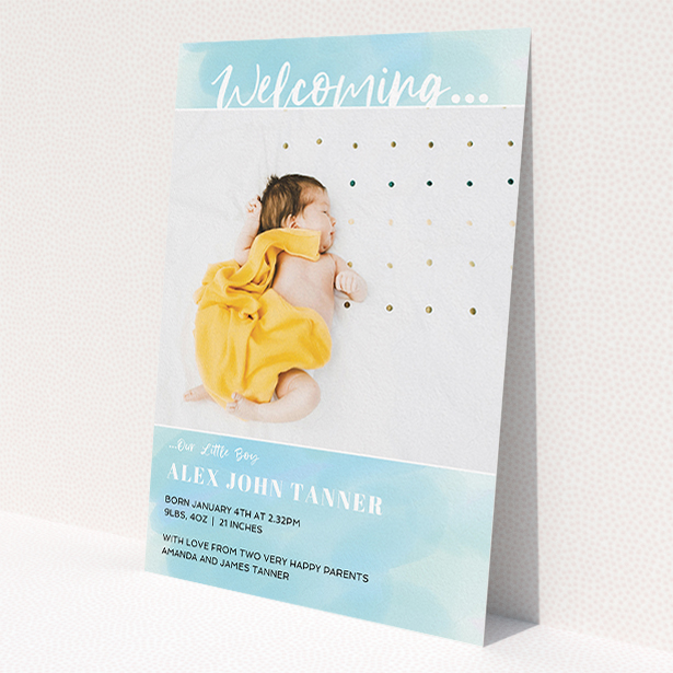 A new baby announcement card called 'Watercolour Welcome'. It is an A5 card in a portrait orientation. It is a photographic new baby announcement card with room for 1 photo. 'Watercolour Welcome' is available as a flat card, with tones of blue and white.