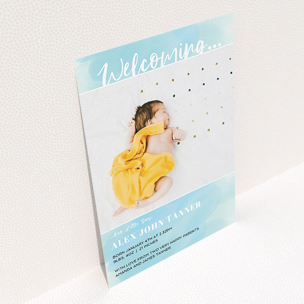 A new baby announcement card called "Watercolour Welcome". It is an A5 card in a portrait orientation. It is a photographic new baby announcement card with room for 1 photo. "Watercolour Welcome" is available as a flat card, with tones of blue and white.