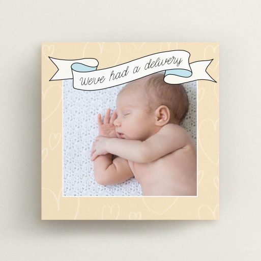 A new baby announcement card named "Written Above". It is a square (148mm x 148mm) card in a square orientation. It is a photographic new baby announcement card with room for 1 photo. "Written Above" is available as a flat card, with tones of faded yellow and light blue.