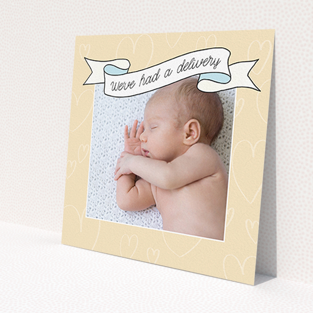A new baby announcement card named 'Written Above'. It is a square (148mm x 148mm) card in a square orientation. It is a photographic new baby announcement card with room for 1 photo. 'Written Above' is available as a flat card, with tones of faded yellow and light blue.