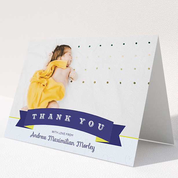 A new baby thank you card named "Big Banner". It is an A5 card in a landscape orientation. It is a photographic new baby thank you card with room for 1 photo. "Big Banner" is available as a folded card, with tones of navy blue and white.