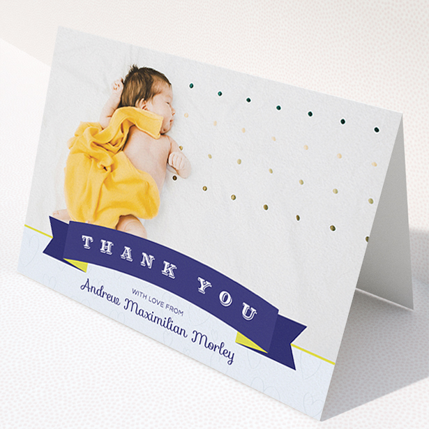 A new baby thank you card named "Big Banner". It is an A5 card in a landscape orientation. It is a photographic new baby thank you card with room for 1 photo. "Big Banner" is available as a folded card, with tones of navy blue and white.