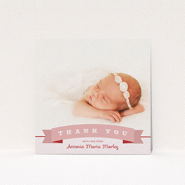 A new baby thank you card design called "Big Banner". It is a square (148mm x 148mm) card in a square orientation. It is a photographic new baby thank you card with room for 1 photo. "Big Banner" is available as a flat card, with tones of pink and white.