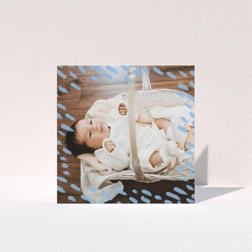 A new baby thank you card named "Blue Daubs". It is a square (148mm x 148mm) card in a square orientation. It is a photographic new baby thank you card with room for 1 photo. "Blue Daubs" is available as a folded card, with mainly blue colouring.