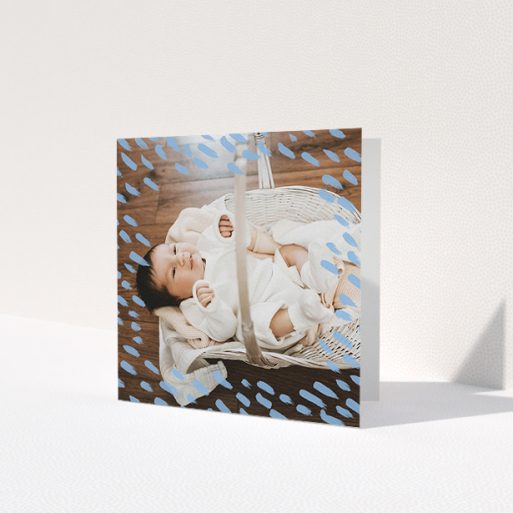 A new baby thank you card named 'Blue Daubs'. It is a square (148mm x 148mm) card in a square orientation. It is a photographic new baby thank you card with room for 1 photo. 'Blue Daubs' is available as a folded card, with mainly blue colouring.