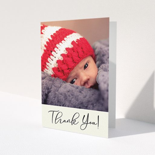 A new baby thank you card called 'Cursive Thanks'. It is an A6 card in a portrait orientation. It is a photographic new baby thank you card with room for 1 photo. 'Cursive Thanks' is available as a folded card, with mainly cream colouring.