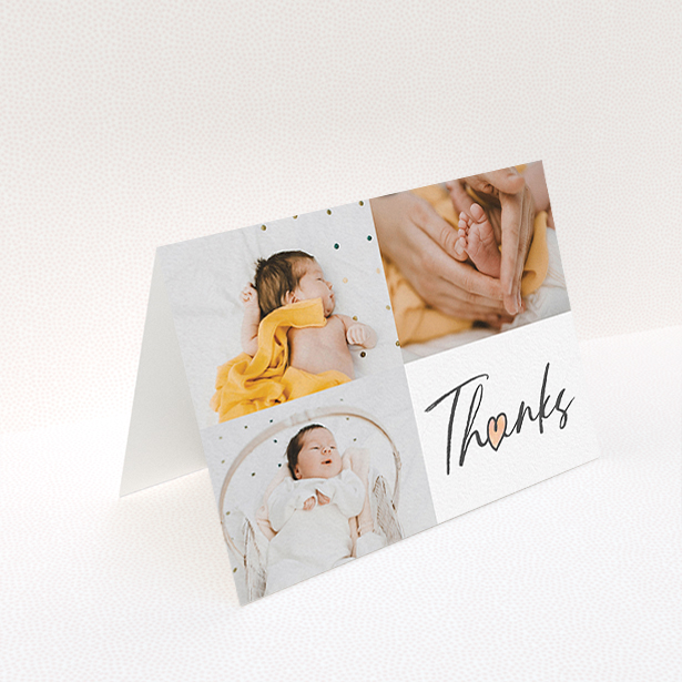 A new baby thank you card named "Handwritten Heart". It is an A6 card in a landscape orientation. It is a photographic new baby thank you card with room for 3 photos. "Handwritten Heart" is available as a folded card, with tones of black and white.