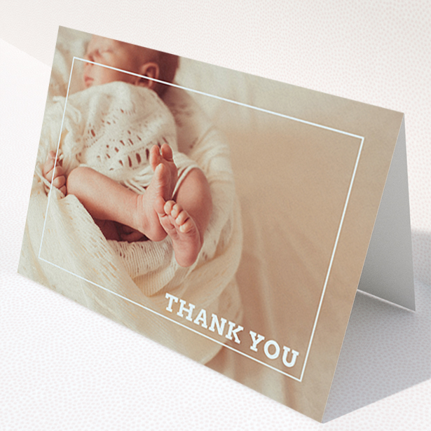 A new baby thank you card design named "Over Photo Frame". It is an A6 card in a landscape orientation. It is a photographic new baby thank you card with room for 1 photo. "Over Photo Frame" is available as a folded card, with mainly white colouring.