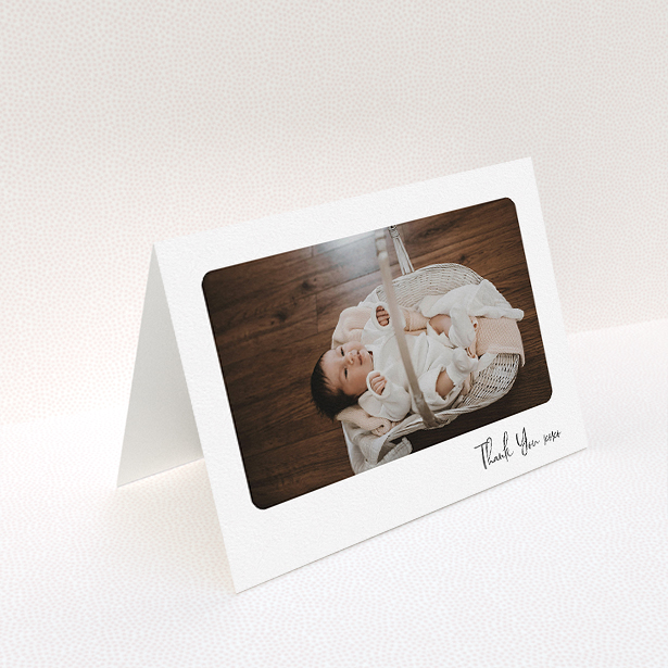 A new baby thank you card template titled "Rounded Thanks". It is an A5 card in a landscape orientation. It is a photographic new baby thank you card with room for 1 photo. "Rounded Thanks" is available as a folded card, with mainly white colouring.