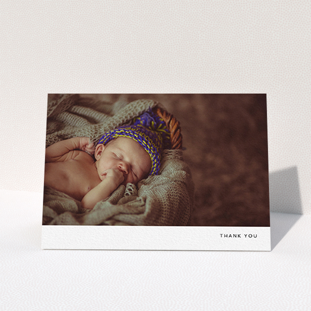 A new baby thank you card design named "Thankful with Simplicity". It is an A6 card in a landscape orientation. It is a photographic new baby thank you card with room for 1 photo. "Thankful with Simplicity" is available as a folded card, with mainly white colouring.