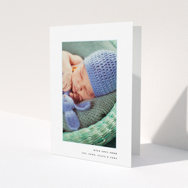A new baby thank you card design titled "Thin Blue Frame". It is an A5 card in a portrait orientation. It is a photographic new baby thank you card with room for 1 photo. "Thin Blue Frame" is available as a folded card, with tones of white and blue.