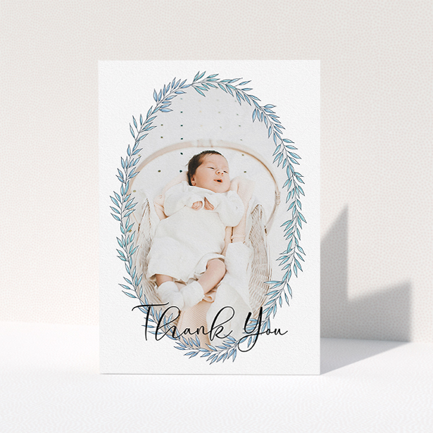 A new baby thank you card named "Tussled Wreath". It is an A5 card in a portrait orientation. It is a photographic new baby thank you card with room for 1 photo. "Tussled Wreath" is available as a folded card, with tones of blue and white.