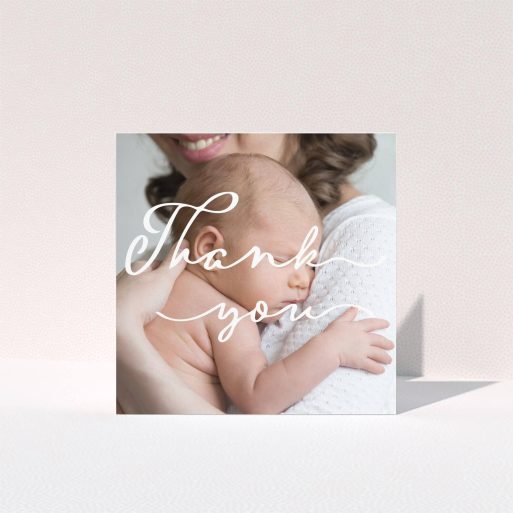 A new baby thank you card design named "White Thank You". It is a square (148mm x 148mm) card in a square orientation. It is a photographic new baby thank you card with room for 1 photo. "White Thank You" is available as a folded card, with mainly white colouring.