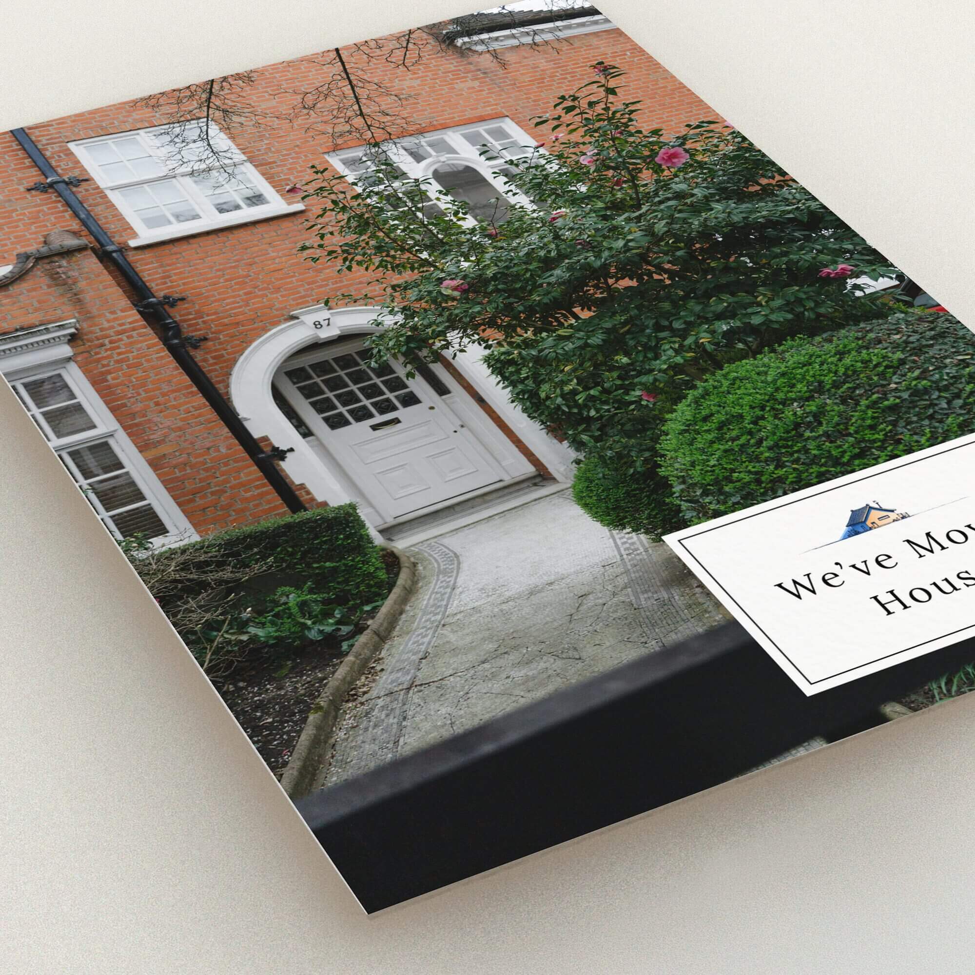 Change of address card featuring a house exterior and one decorative photo.