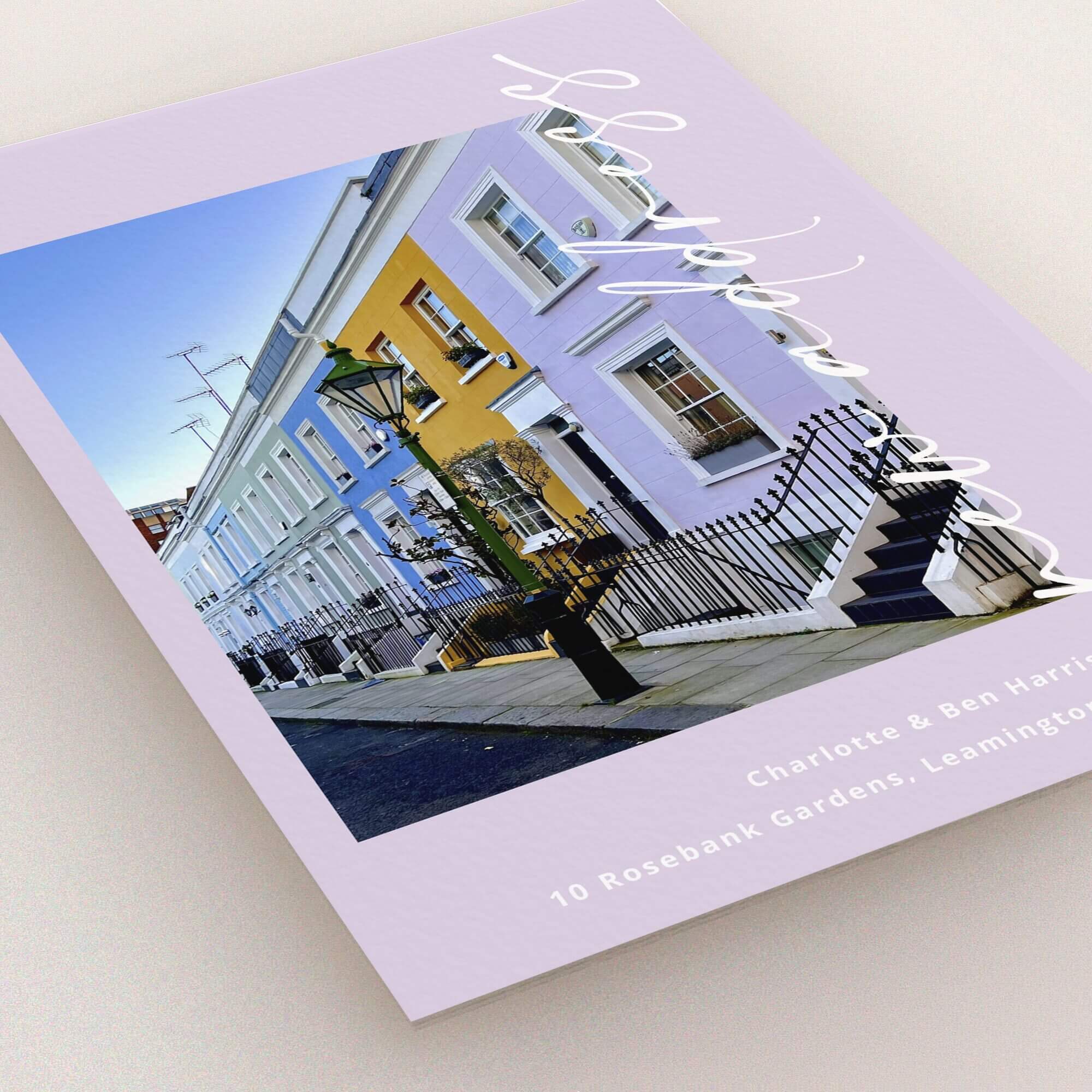 Change of address card design featuring colourful houses on a street with one photo.