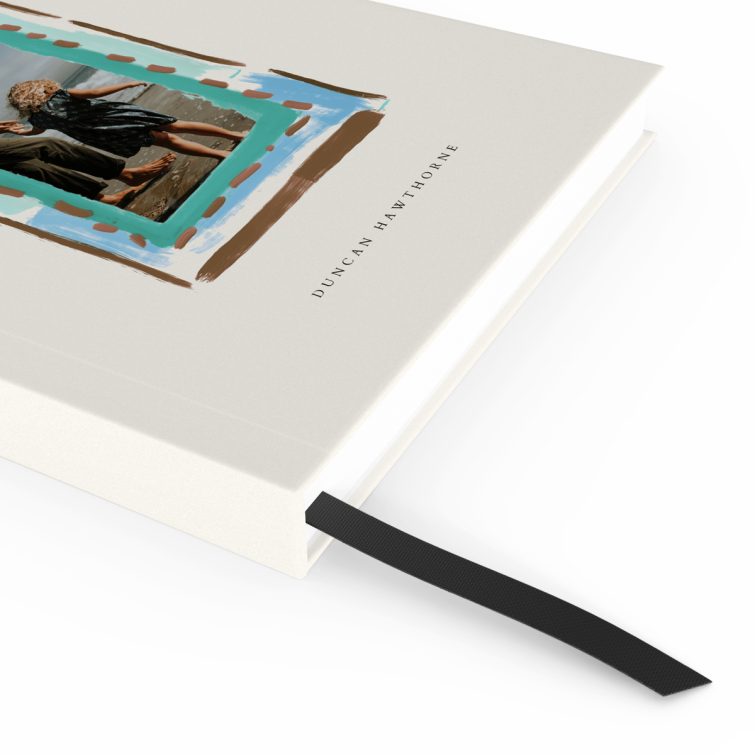 Elegant portrait notebook design with a playful painted border on the cover, featuring one photo.