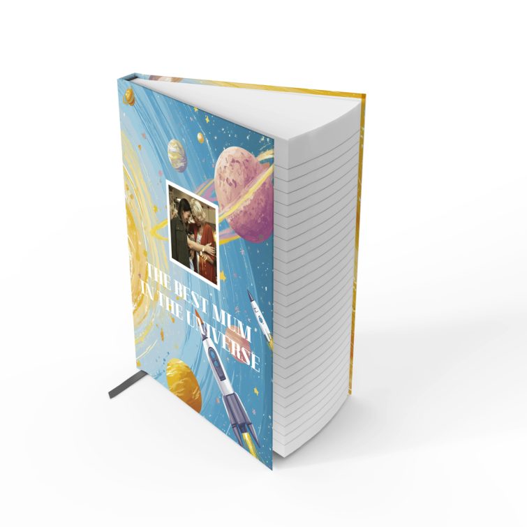 Colourful space-themed notebook design featuring planets and rockets with one photo on the front cover.