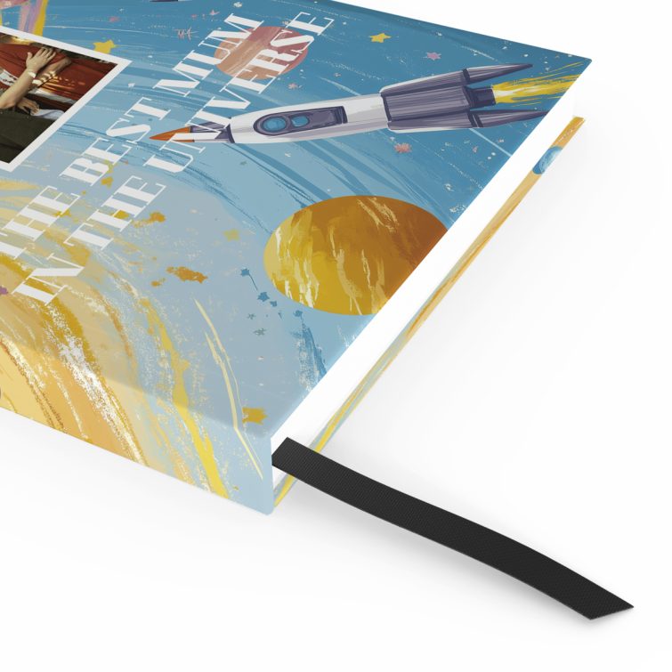 Colourful space-themed notebook design featuring planets and rockets with one photo on the front cover.