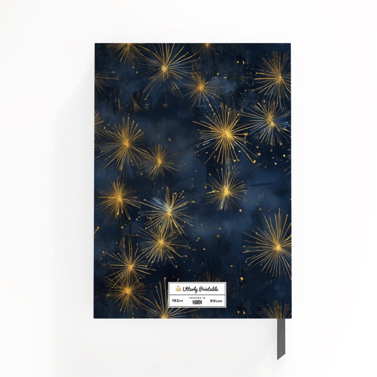 Elegant starburst design on a portrait orientation notebook cover with Utterly Printable branding, featuring gold and navy colour scheme.