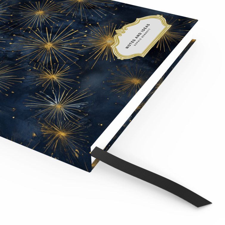 Elegant starburst design on a portrait orientation notebook cover with Utterly Printable branding, featuring gold and navy colour scheme.