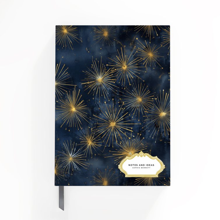 Elegant starburst design on a portrait orientation notebook cover with Utterly Printable branding, featuring gold and navy colour scheme.