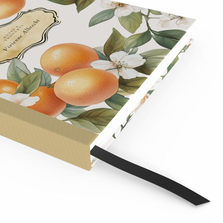 Floral and citrus-themed portrait notebook cover design with orange and white blossoms, featuring three decorative photos.